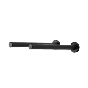 Pair of matte black cork-forward wine pegs mounted to a white wall
