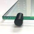 Black shelf clamp gripping the edge of a thick clear glass shelf