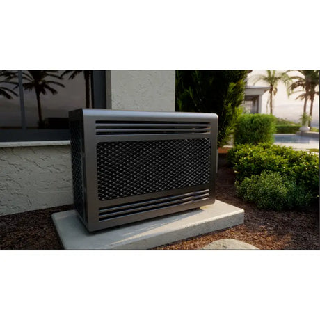 Condensing unit on a concrete pad beside a stucco house with palms and a pool behind