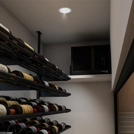 Cellar corner with the Platinum Split evaporator mounted high on the wall above angled racking